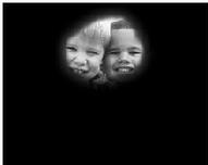 Image of two smiling boys surrounded by black effect